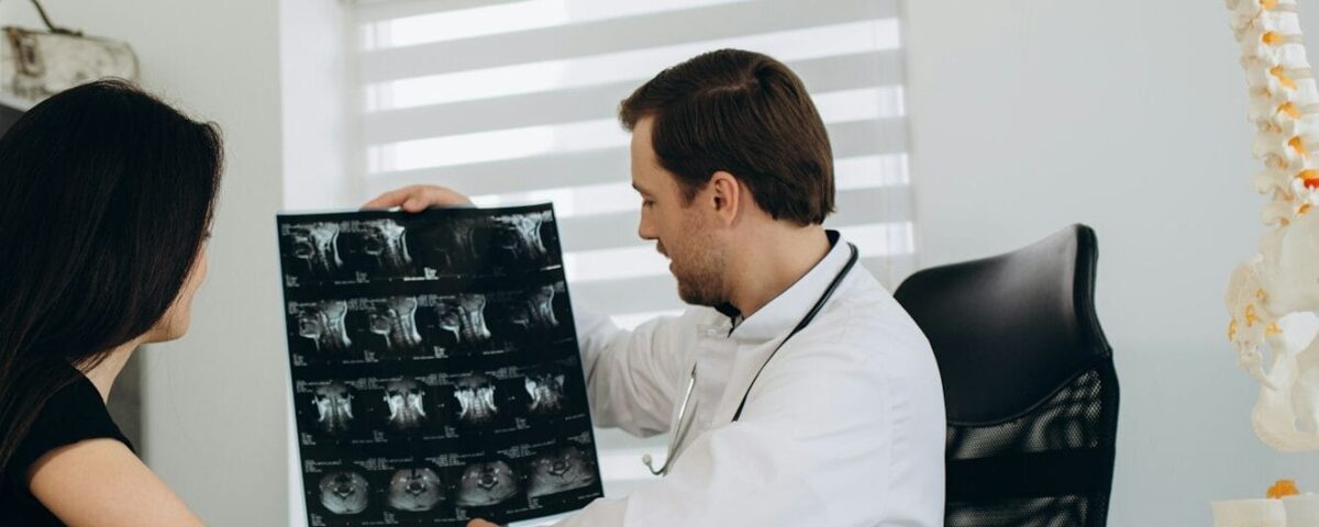 Female patient examining spine at physiotherapist at vertebrology center