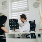 Female patient examining spine at physiotherapist at vertebrology center