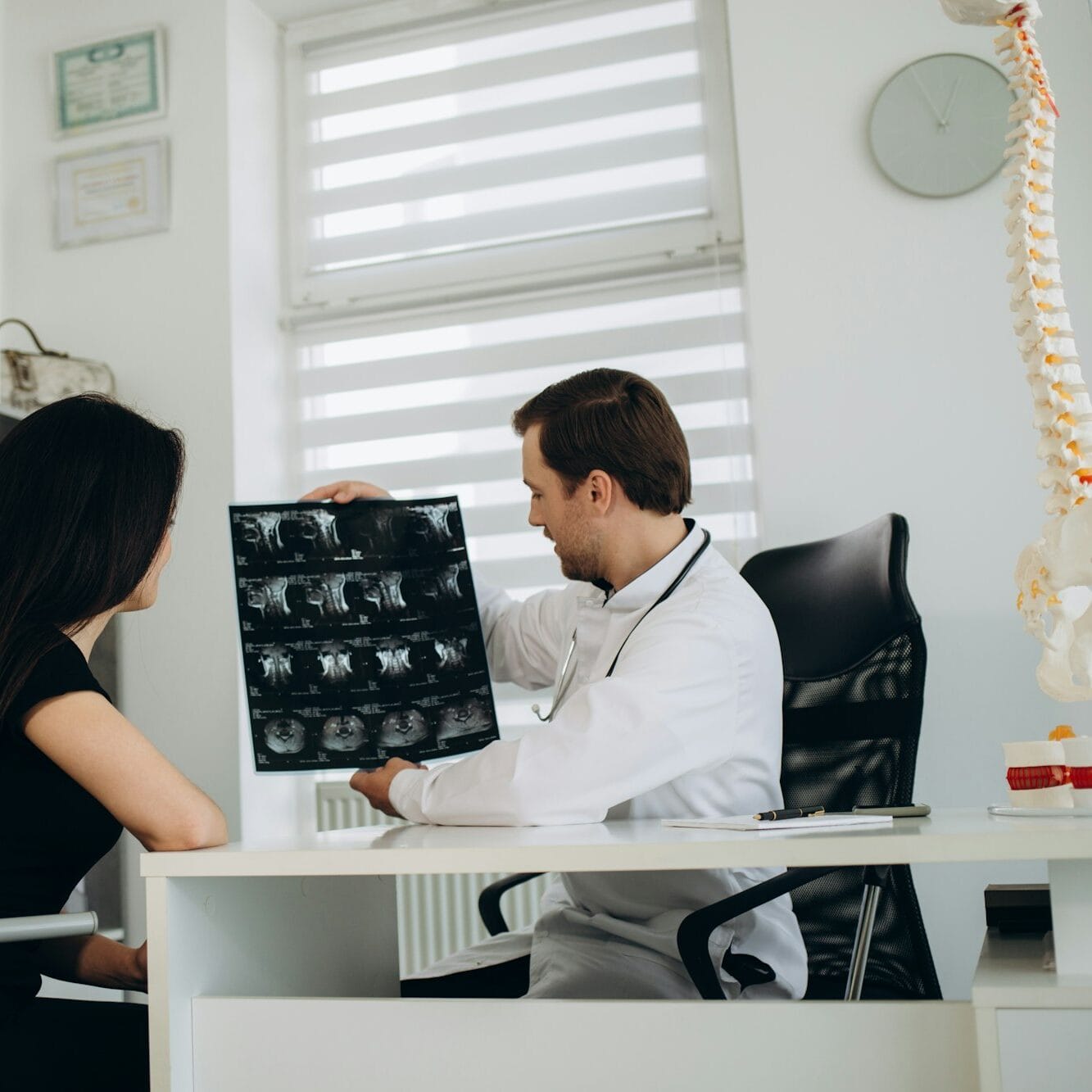 Female patient examining spine at physiotherapist at vertebrology center
