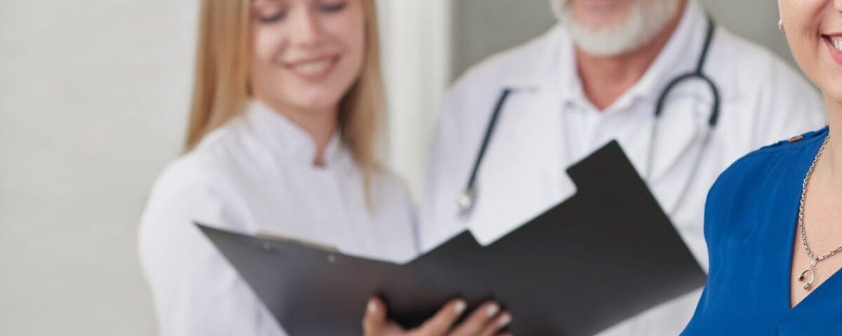 Happy patient and doctors posing, smiling